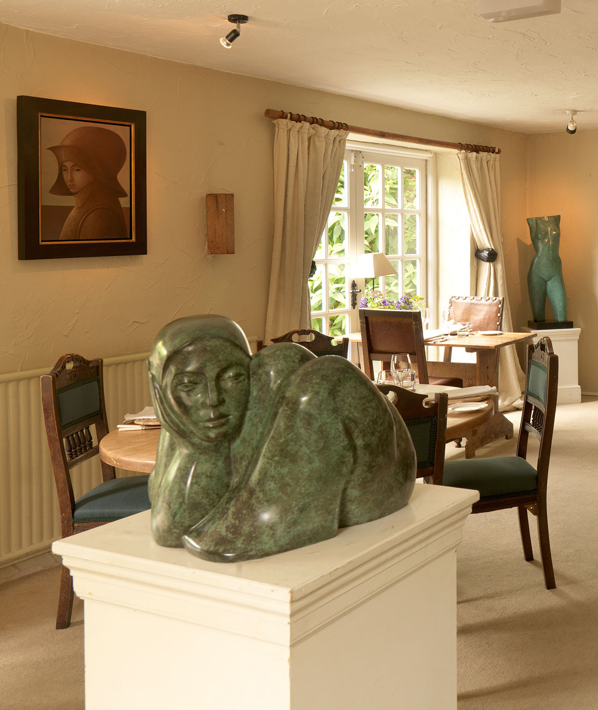Sculpture of Girl curled, in dining room, by Michael Cooper.